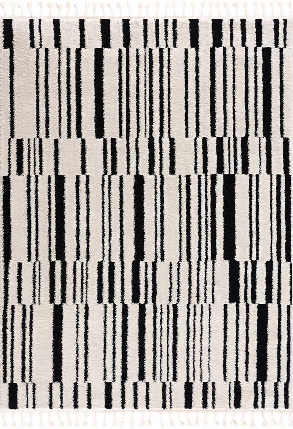 Close up of the Bansi Area Rug, a geometric design in beige and black with tassels. Design-Rectangle-46