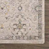 Close-up of the Annie Cream Textured Rug showing its farmhouse style pattern and soft, neutral colors on a wood floor. Swatch