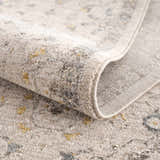 Close-up of the Annie Cream Textured Rug with Fringes showing the cotton and polyester blend, and machine woven construction. Fold