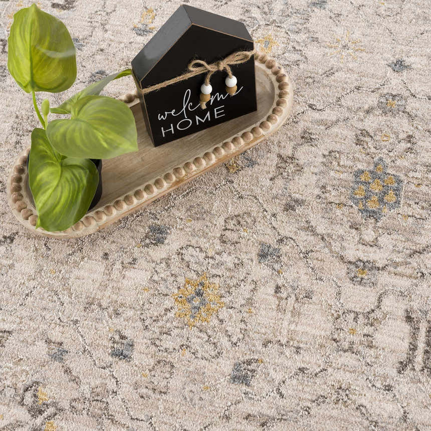 Close-up of the Annie Cream Textured Rug with floral patterns and a neutral color palette. Styleshot