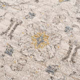 Close-up of the Annie Cream Textured Rug with floral design in cream, gray and gold tones. Texture