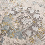 Close-up of the Alroy Textured Rug. Features a gray, brown, and natural abstract pattern with a soft, textured pile. Texture