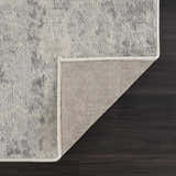 Close-up of the Tigrima Ivory 2319 area rug showing its ivory and gray contemporary pattern and durable woven backing. Fold
