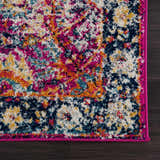 Close up of New Vick Area Rug featuring a bright pink border and a colorful traditional pattern. Corner