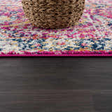 Close up of the New Vick Area Rug showing its pink, blue, and yellow traditional pattern. Pile