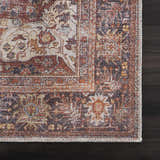 Close-up of the Rust Elki Vintage Medallion Washable Area Rug, showing rust, blue, and off-white Persian-style pattern. Swatch