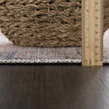 Close-up of the Rust Elki Vintage Medallion Washable Area Rug showing the rug's thickness with a ruler. Pile