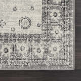 Close up of the gray and ivory Marash 4605 area rug showing traditional floral pattern and soft texture. Corner