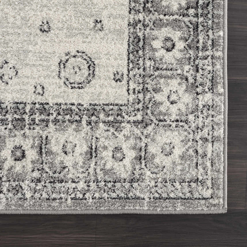 Close up of the gray and ivory Marash 4605 area rug showing traditional floral pattern and soft texture. Corner
