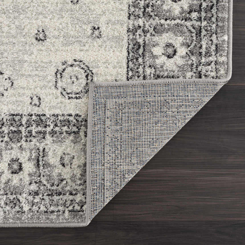 Close-up of the Marash 4605 Gray Area Carpet showing its gray, ivory, and silver gray contemporary pattern and machine-made construction. Fold