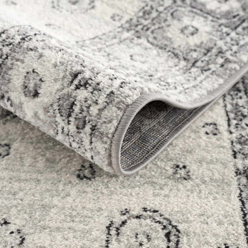Close-up of the Marash 4605 Gray Area Carpet showing its traditional pattern, soft texture, and gray, ivory, and silver gray colors. Fold