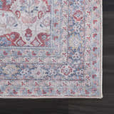 Close-up of the Rust Goma Vintage Area Rug showing blush, red, cream, and blue floral pattern and textured machine woven construction. Swatch