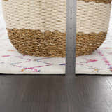 Close-up of the Marash KMRSH-4600 rug showing pile height. Off-white rug with colorful bohemian pattern and a measuring ruler. Pile