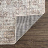 Close up of the Niran Area Rug showing the vintage pattern, soft texture, and durable backing. Fold