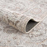 Close-up of the Niran Area Rug showing its traditional vintage pattern, polyester and cotton blend, and machine-woven construction. Fold