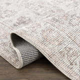 Close up of the Niran Area Rug showing its vintage pattern and woven texture. Fold