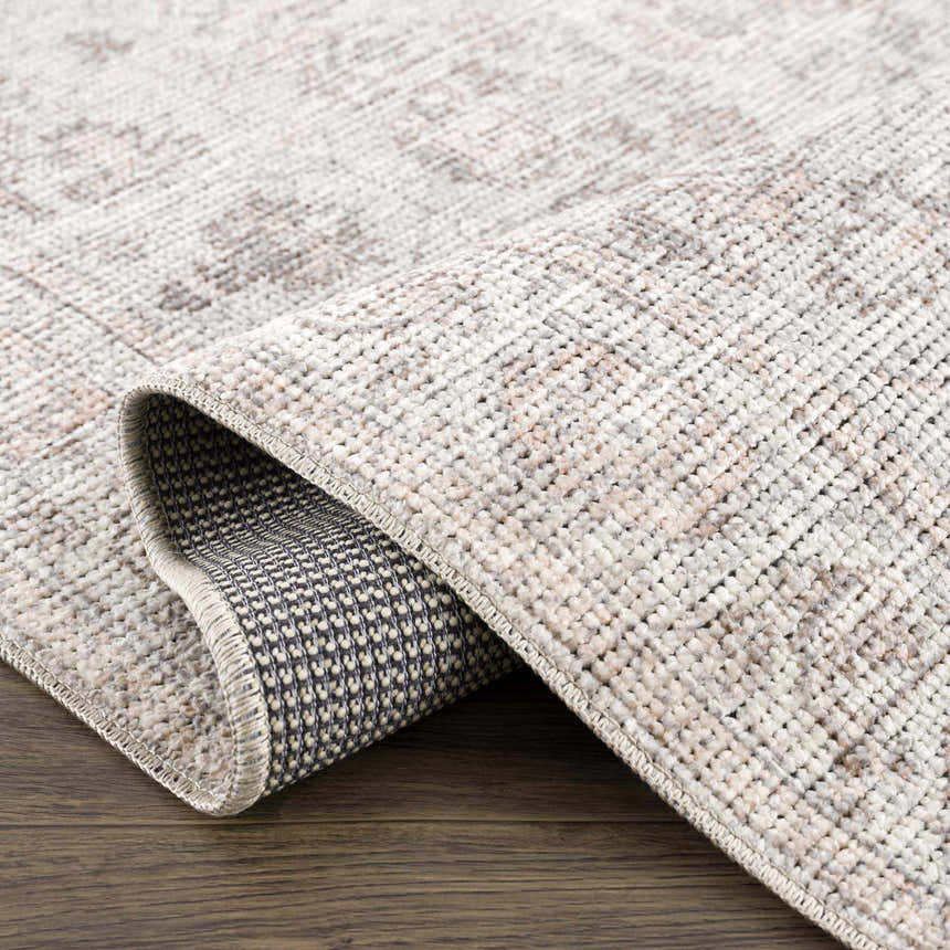 Close up of the Niran Area Rug showing its vintage pattern and woven texture. Fold