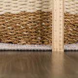 Close-up of Niran area rug showing detail of the rug's edge, texture, and pile height with a ruler for scale. Pile