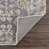 Close-up of the Metin Area Rug showing the light gray and natural gray traditional pattern and machine woven construction. Fold