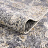 Close-up of the Metin Area Rug showing light gray and natural gray colors, woven texture, and backing. Fold
