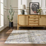 Living room scene with a light gray Metin Area Rug, wood floors, and a cane-front console table. Roomscene-Rectangle