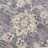 Close-up of the Metin Area Rug, showing its light gray and natural gray farmhouse pattern and textured, machine-woven construction. Texture
