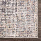 Close-up of the Nyota Area Rug. Traditional vintage style with gray, beige, and brown tones. Machine-woven texture. Corner