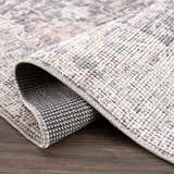 Close up of rolled Nyota Area Rug showing traditional vintage pattern and texture. Fold