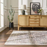 Living room scene with a vintage style Nyota Area Rug, wood floors, and a light wood cabinet. Roomscene-Rectangle