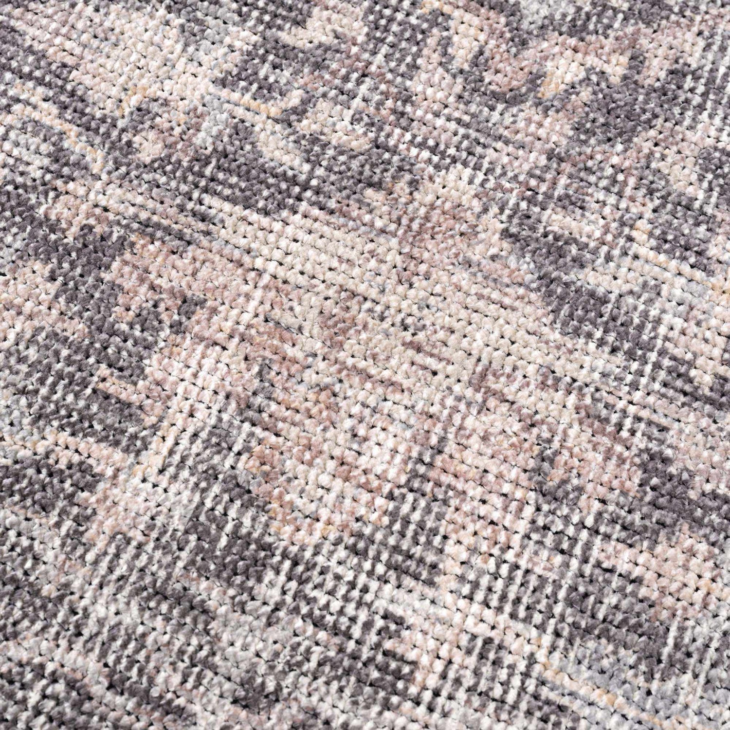 Close-up of the Nyota Area Rug. Machine-woven polyester rug with a traditional vintage design in gray, beige, and white. Texture
