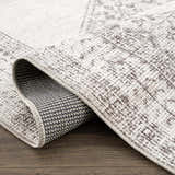 Close-up of the Mortye Cream & Brown Medallion Area Rug showing its texture, backing, and traditional vintage design. Fold