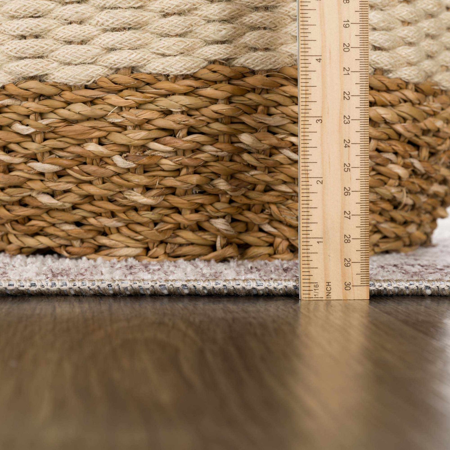 Close-up of the Mortye Cream & Brown Medallion Area Rug edge and pile height, with a ruler for scale. Pile