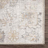 Close-up of the Melor Area Rug. The rug has a traditional vintage design with beige, gray, and ivory tones. Swatch