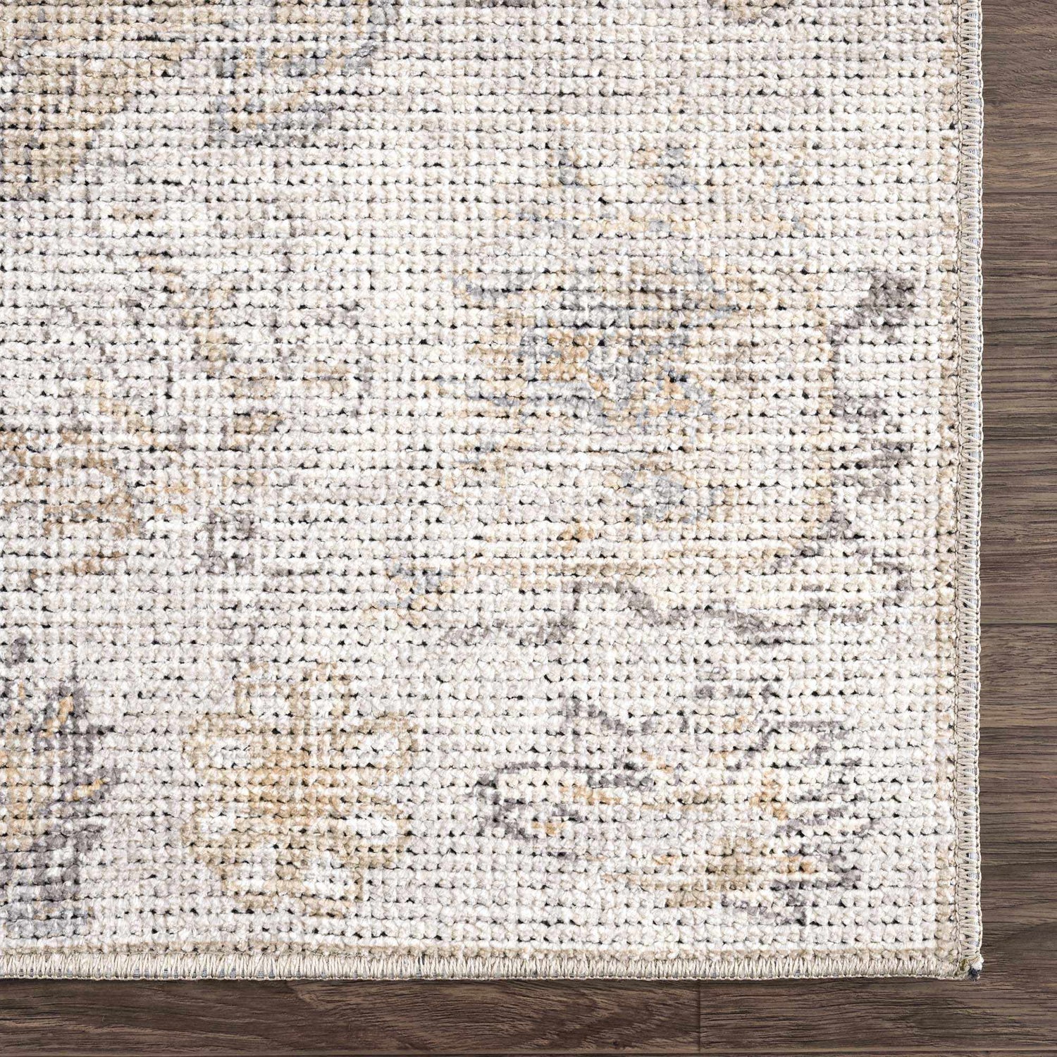 Close-up of the Melor Area Rug. The rug has a traditional vintage design with beige, gray, and ivory tones. Swatch