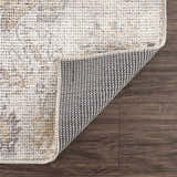 Close-up of the Melor Area Rug showing its traditional vintage pattern, texture, and backing on a wood floor. Fold