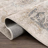 Close-up of the Melor Area Rug showing the traditional vintage pattern, soft texture, and durable backing. Fold