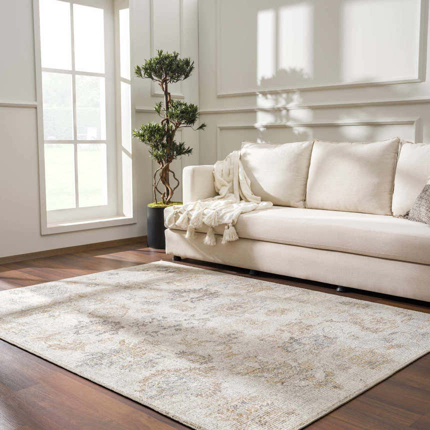 Living room with a beige sofa and the vintage-style Melor Area Rug in neutral tones on a dark wood floor. Roomscene-Rectangle