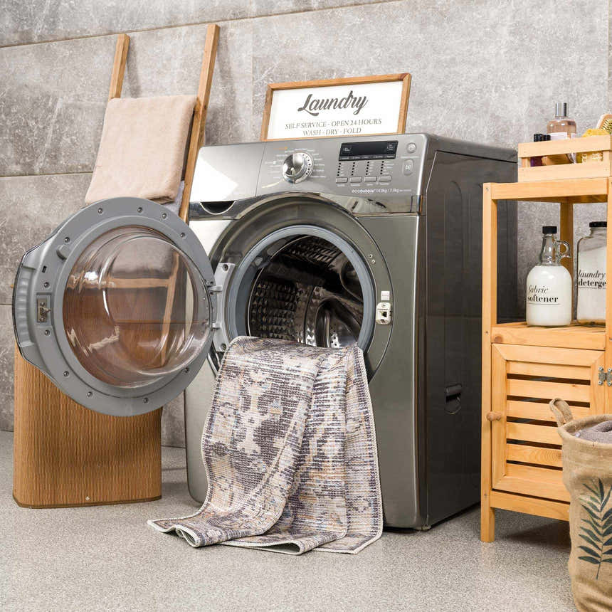Okoth Area Rug in a laundry room with a washing machine, wooden ladder, and storage cabinet. Farmhouse style. Washing-Machine