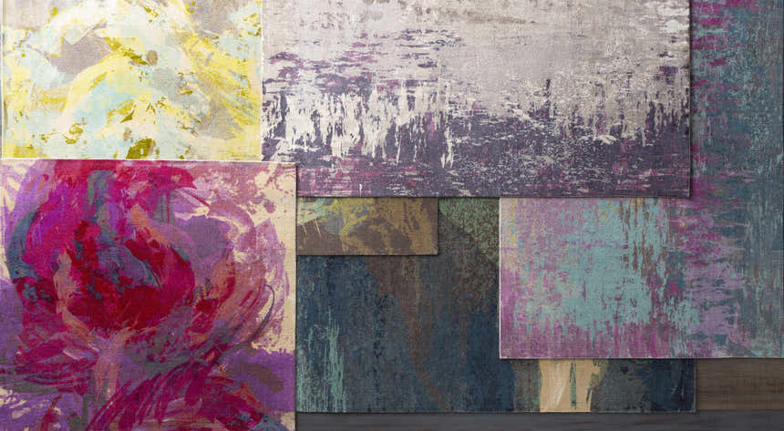 Close-up of Alvaton Abstract Blue Rug showing a variety of abstract patterns and colors: blue, gray, peach, and beige. Styleshot