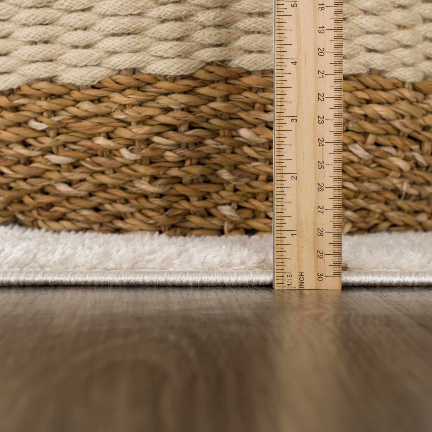 Close up of the Keanu Area Rug showing its texture, pile height, and beige, brown and off-white colors. Pile