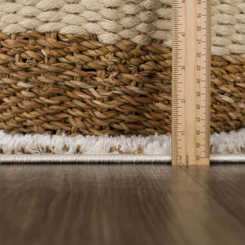 Close-up of the Julio Scandi Boho Area Rug showing the ivory shag texture and brown woven pattern with a ruler for scale. Pile