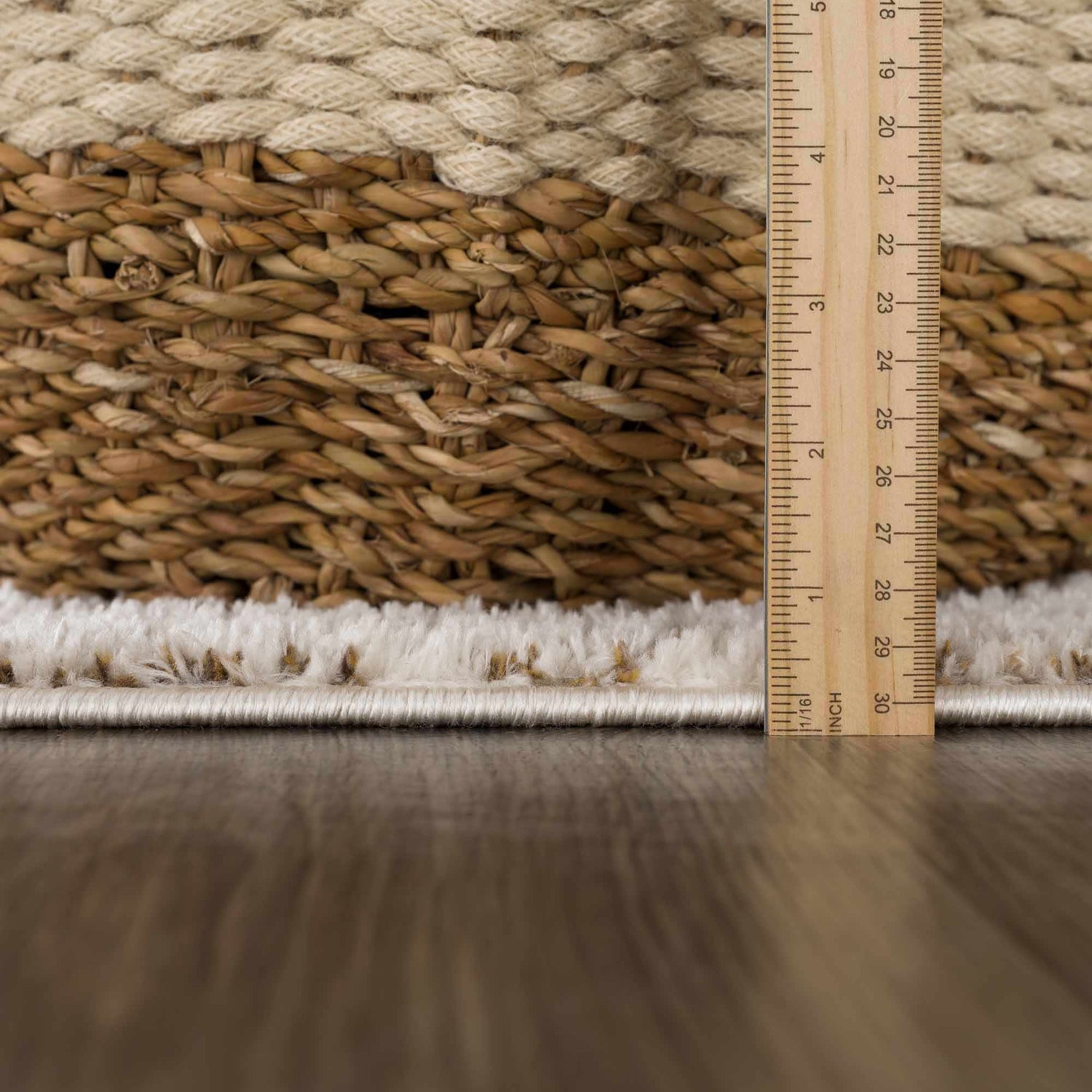 Close-up of the Julio Scandi Boho Area Rug showing the ivory shag texture and brown woven pattern with a ruler for scale. Pile