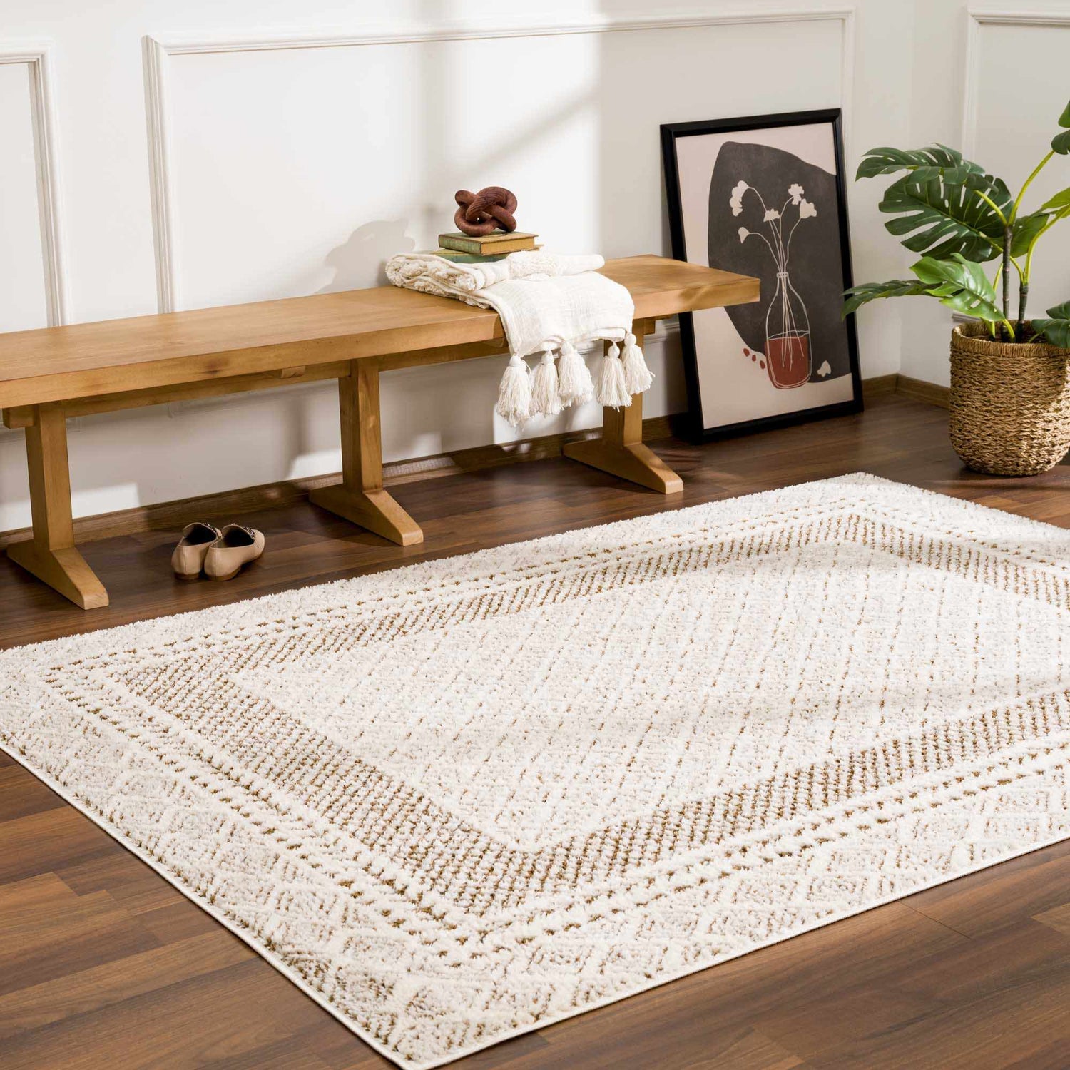 Entryway with wood bench and the beige Julio Scandi Boho Area Rug on a dark wood floor. Plant and art complete the look. Roomscene-Rectangle