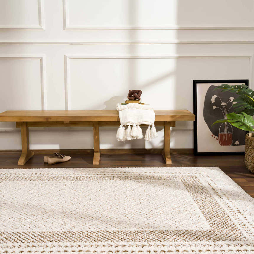 Entryway with a light wood bench and the beige Julio Scandi Boho Area Rug on a dark wood floor. Roomscene-Rectangle