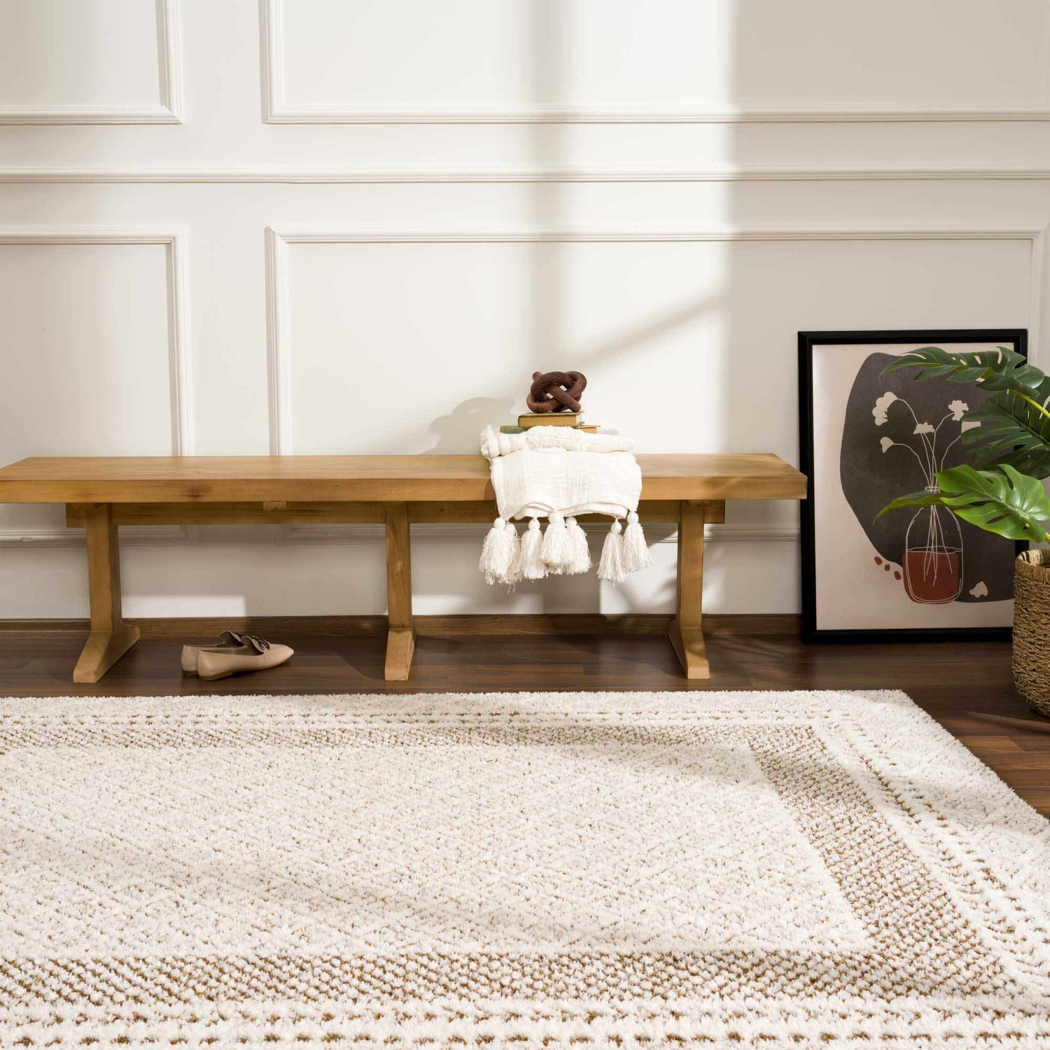 Entryway with a light wood bench and the beige Julio Scandi Boho Area Rug on a dark wood floor. Roomscene-Rectangle