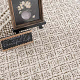 Close-up of the Julio Scandi Boho Area Rug in brown, beige, and ivory with a geometric pattern and soft texture. Styleshot