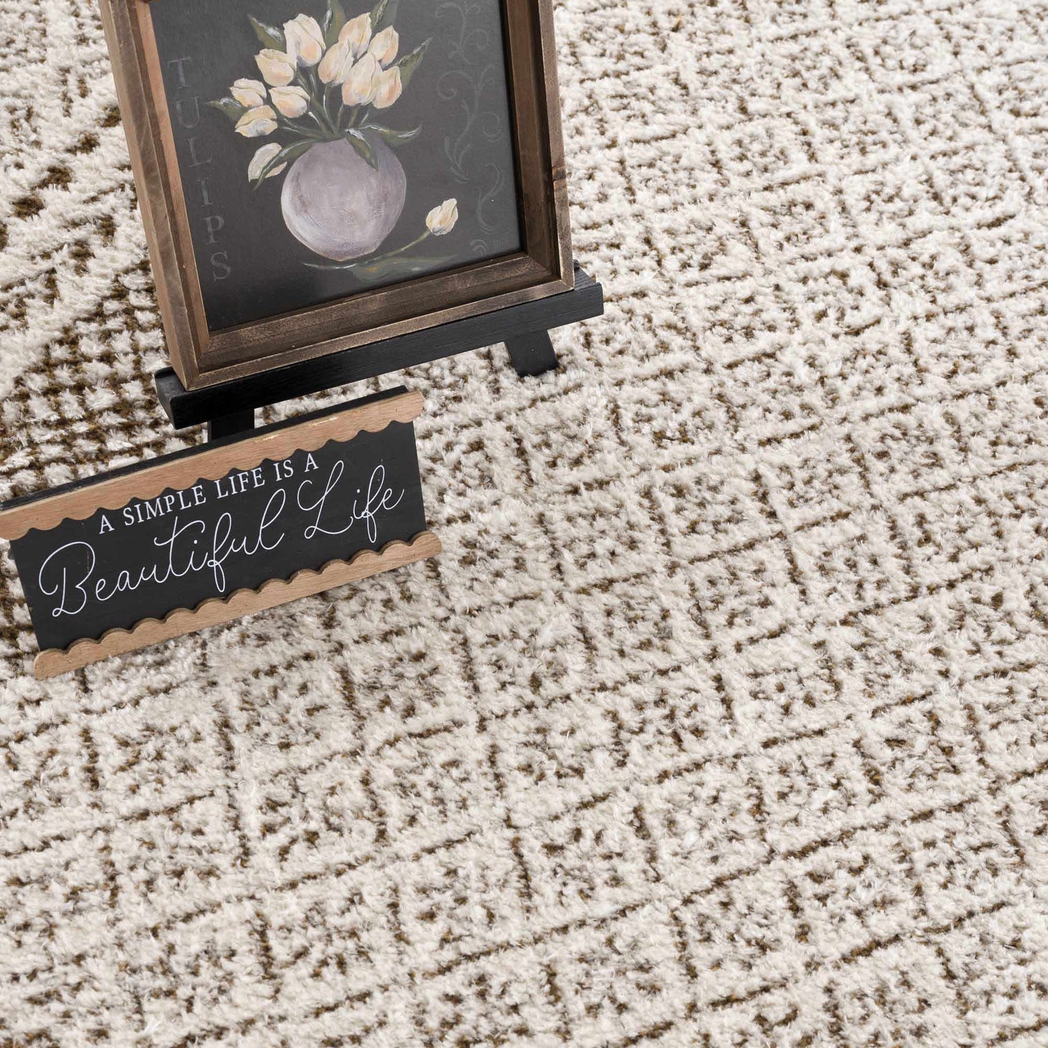 Close-up of the Julio Scandi Boho Area Rug in brown, beige, and ivory with a geometric pattern and soft texture. Styleshot