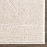 Close up of the ivory Keone area rug showing its plush texture and geometric design. Swatch