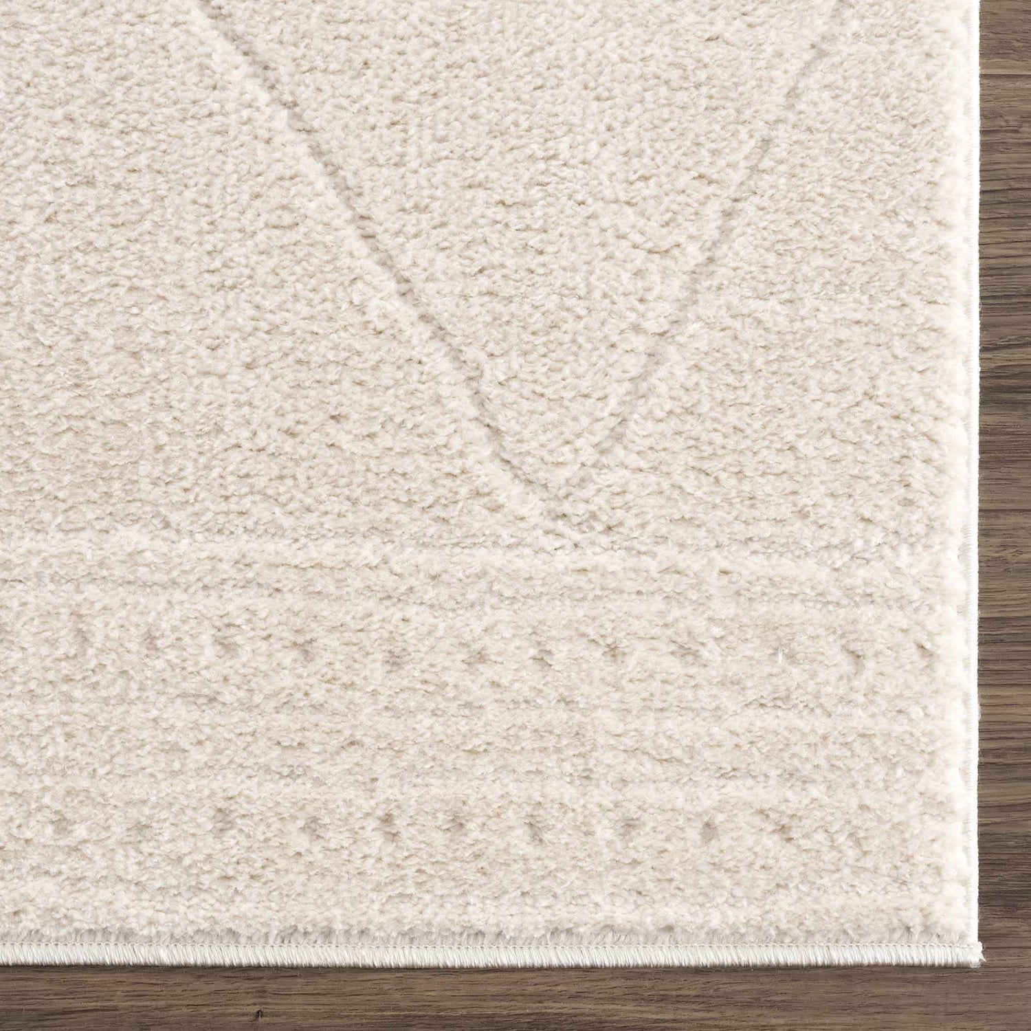 Close up of the ivory Keone area rug showing its plush texture and geometric design. Swatch