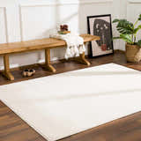 Entryway with wood bench, plant, and ivory Keone rug on dark wood floor. Roomscene-Rectangle